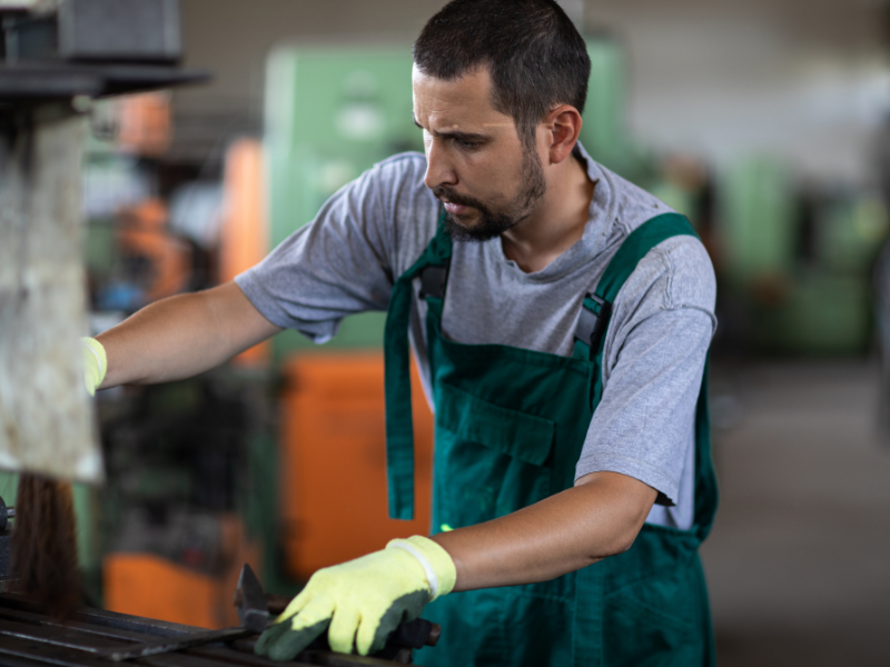 allow employees to dress up for halloween - safety first/ worker using factory equipment